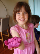 girl holding clay project in hand